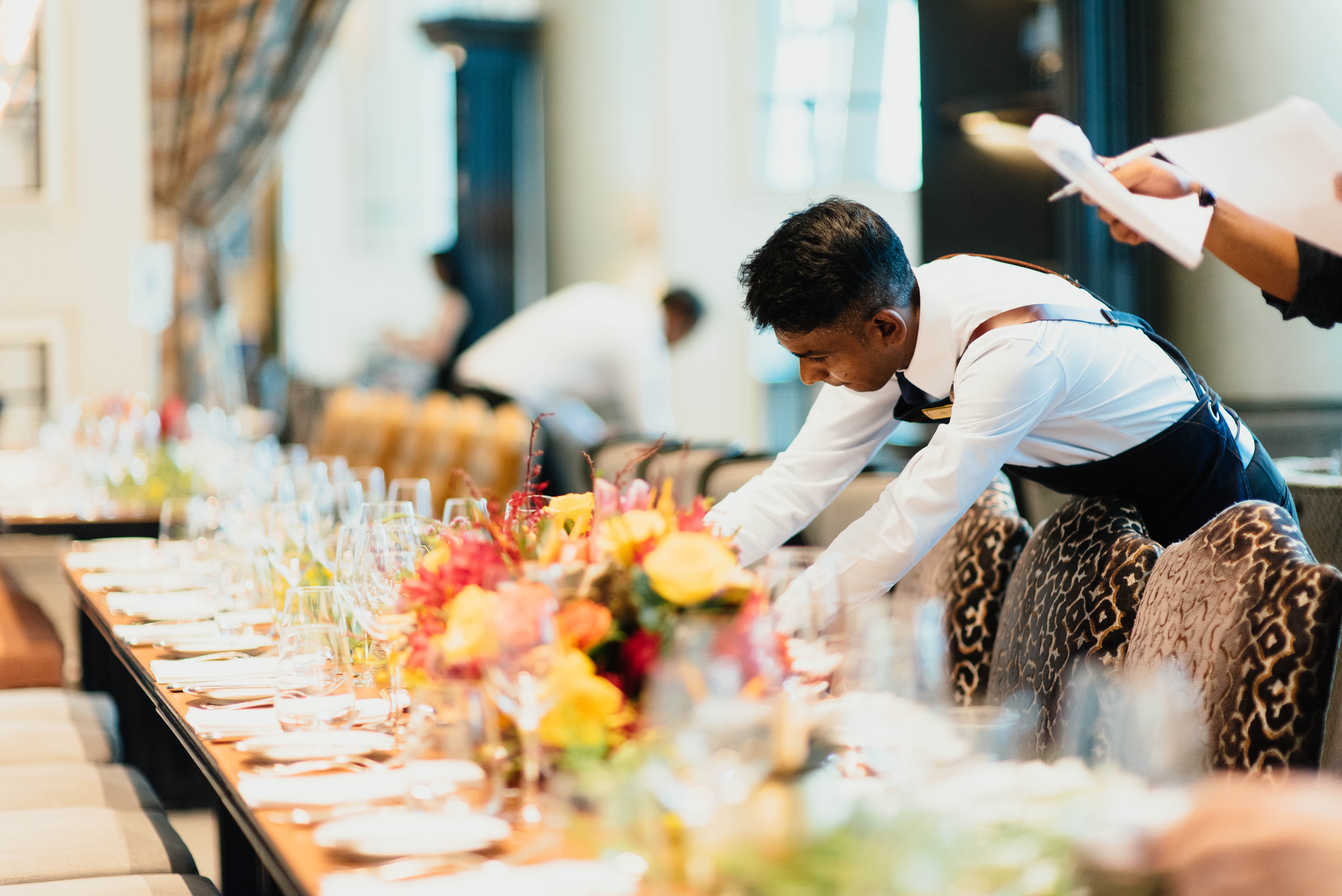 Waiters laying a long grand table