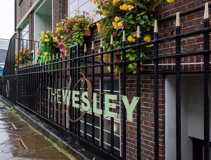The Wesley hotel sign on the railings outside The Wesley hotel