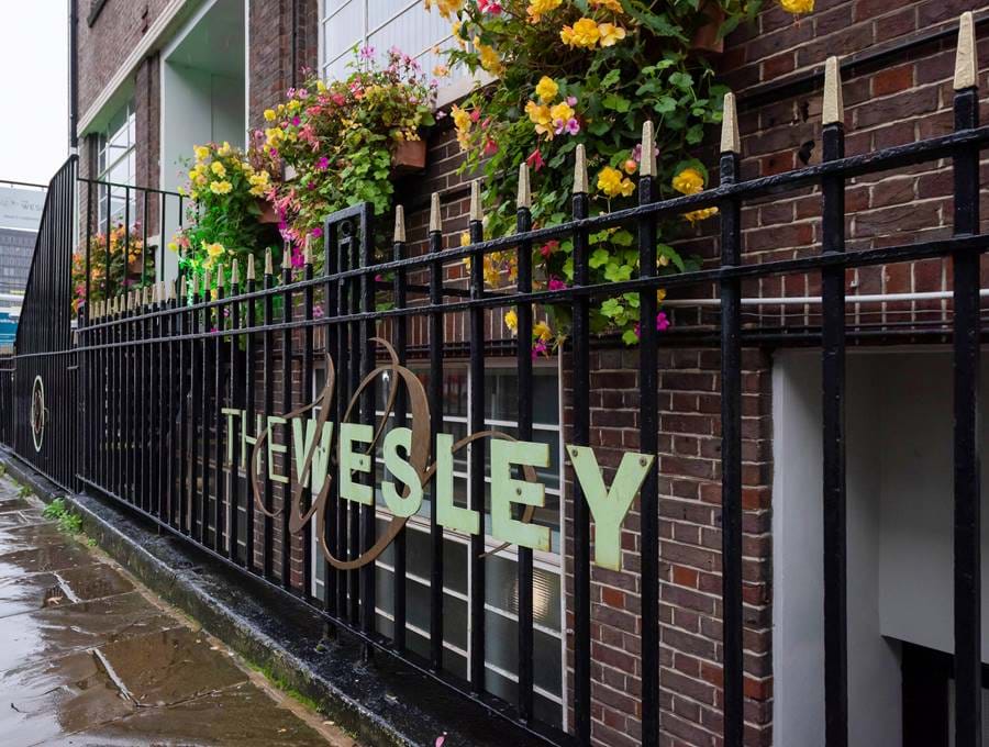 The Wesley hotel sign on the railings outside The Wesley hotel