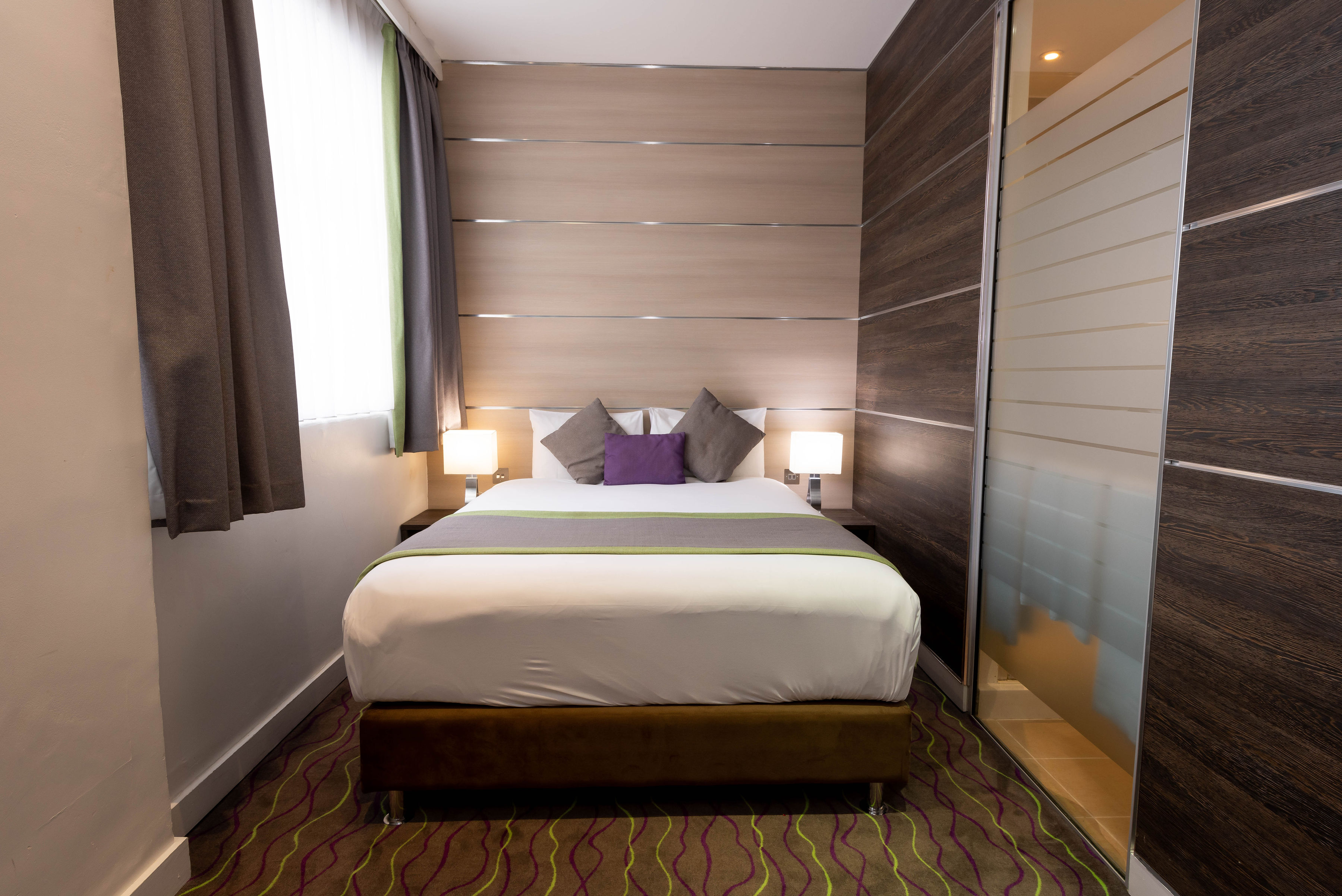 The bed within the superior bedroom of the Wesley Euston Hotel