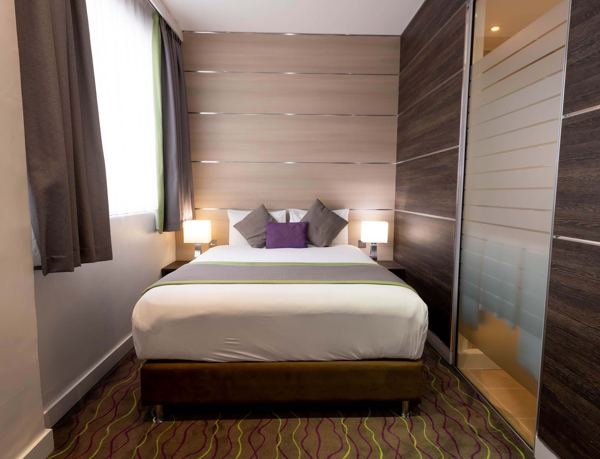 The bed within the superior bedroom of the Wesley Euston Hotel