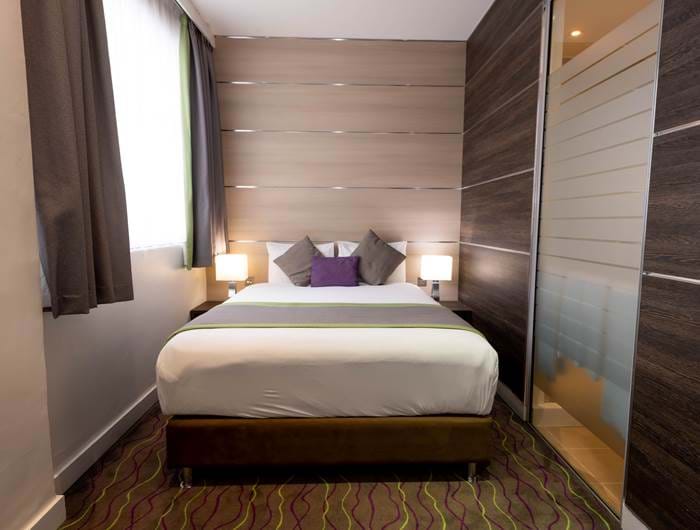 The bed within the superior bedroom of the Wesley Euston Hotel