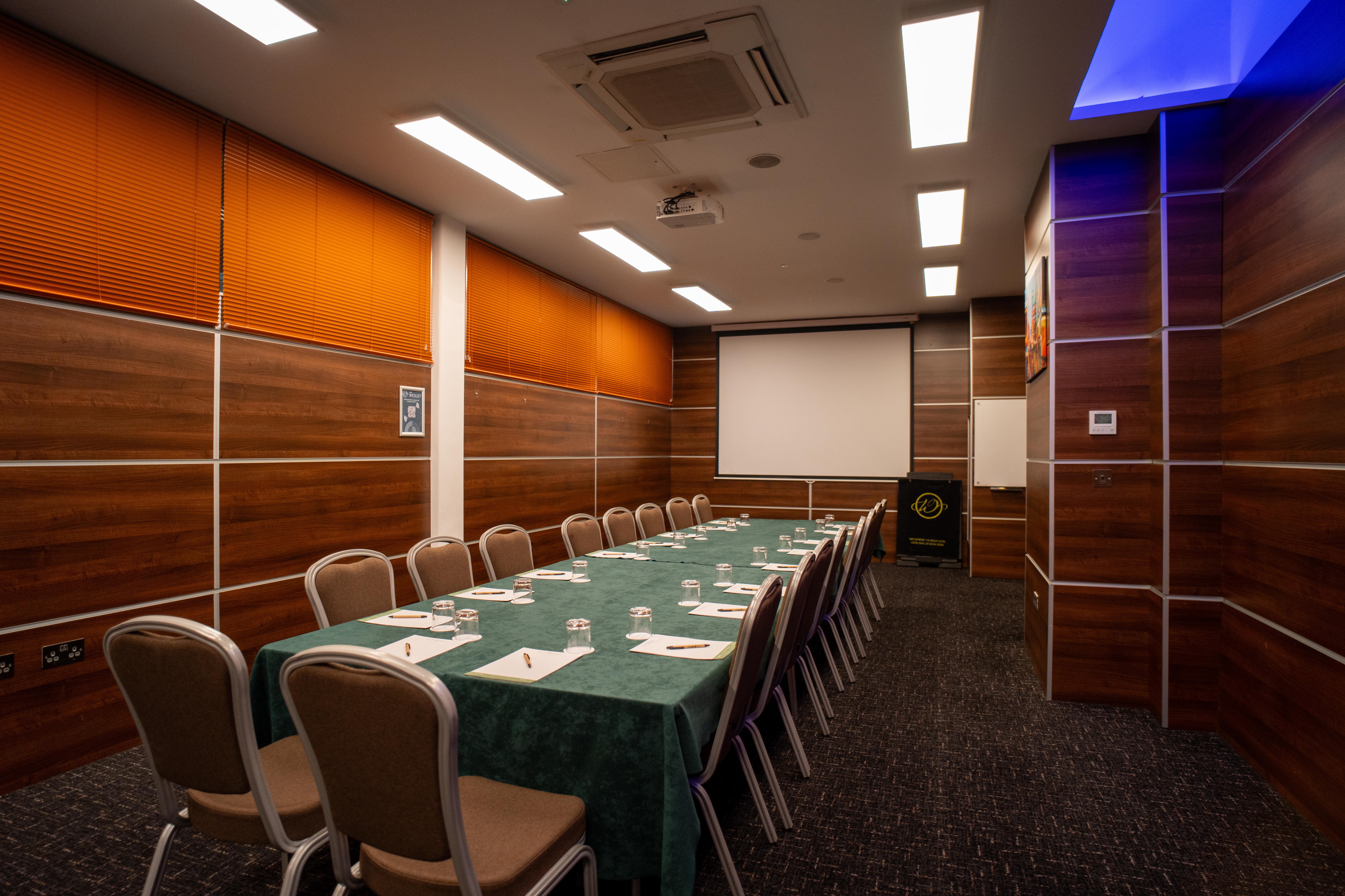 Meeting room at The Wesley set up with pens and notepads