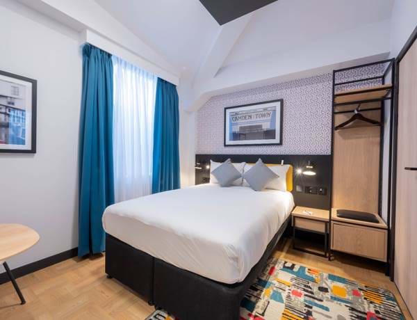 The double bed and vibrant decor of the superior bedroom at The Wesley's Camden hotel