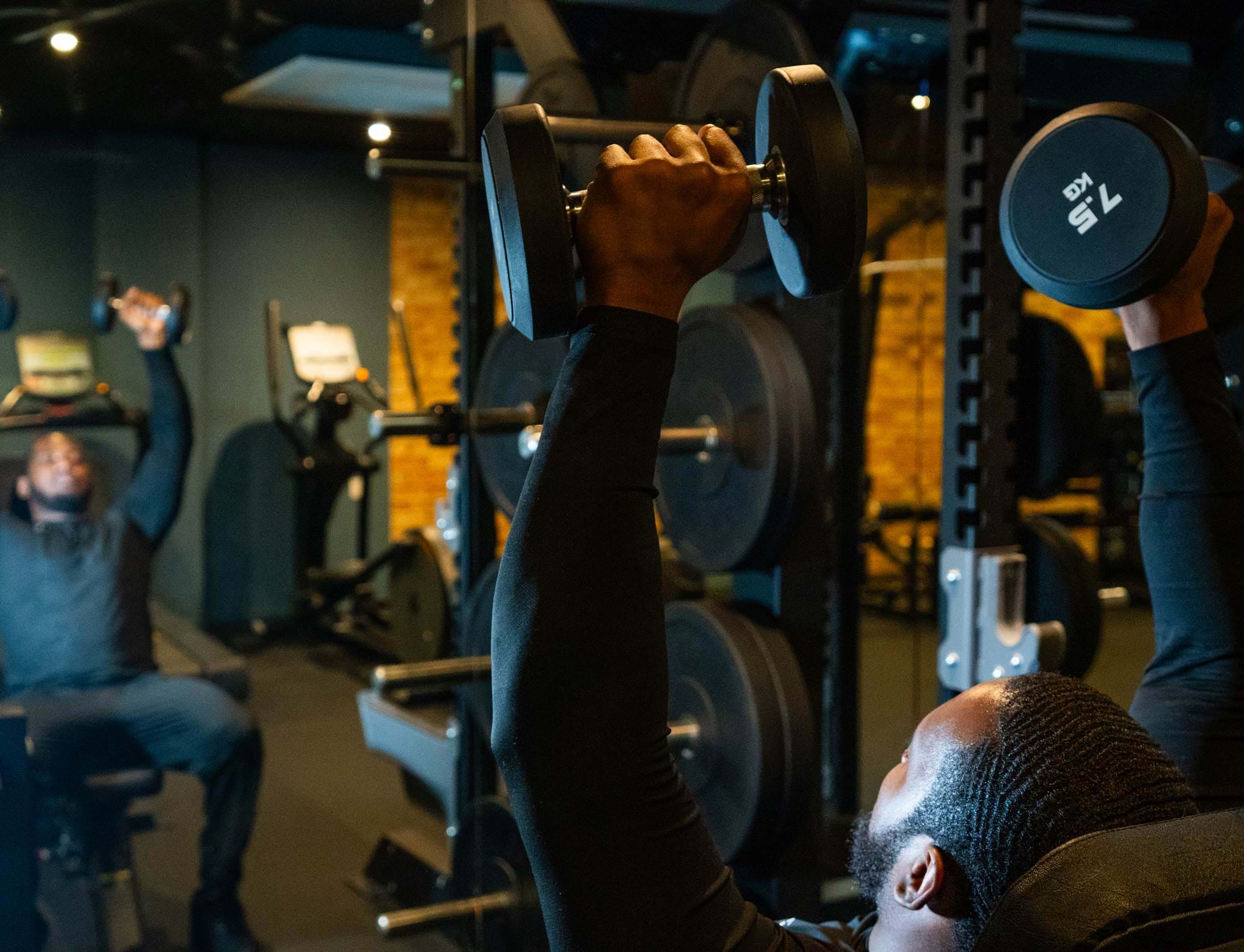 Man lifting weights at the gym at The Wesley