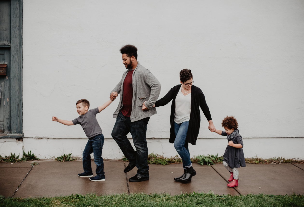 A family of four walking after staying at The Wesley Hotel in Central London
