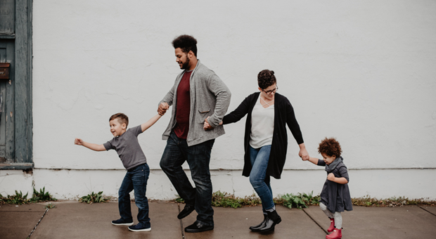 A family of four walking after staying at The Wesley Hotel in Central London