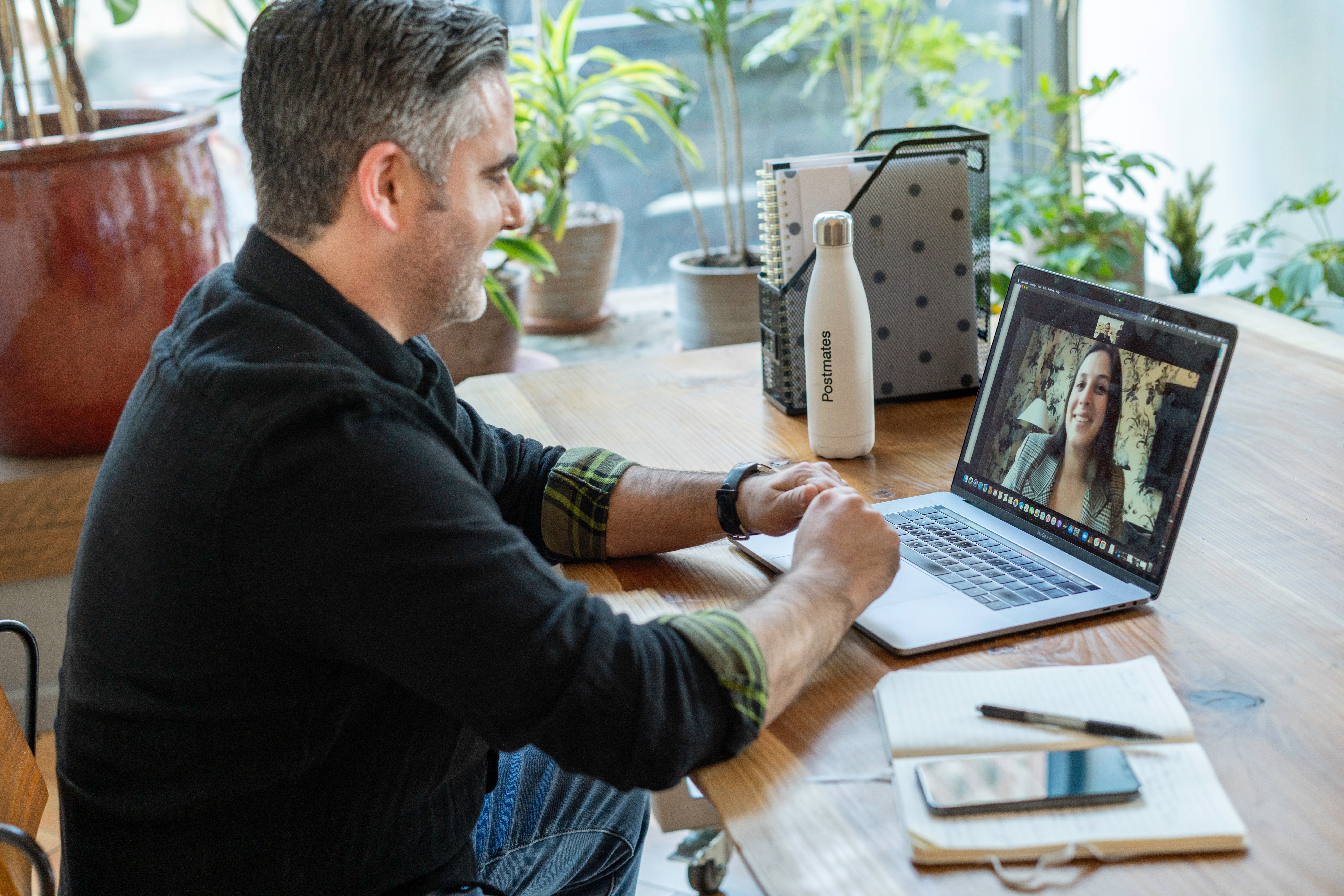 Man talking a woman on a zoom meeting 