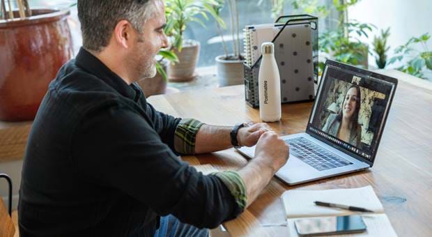 Man talking a woman on a zoom meeting