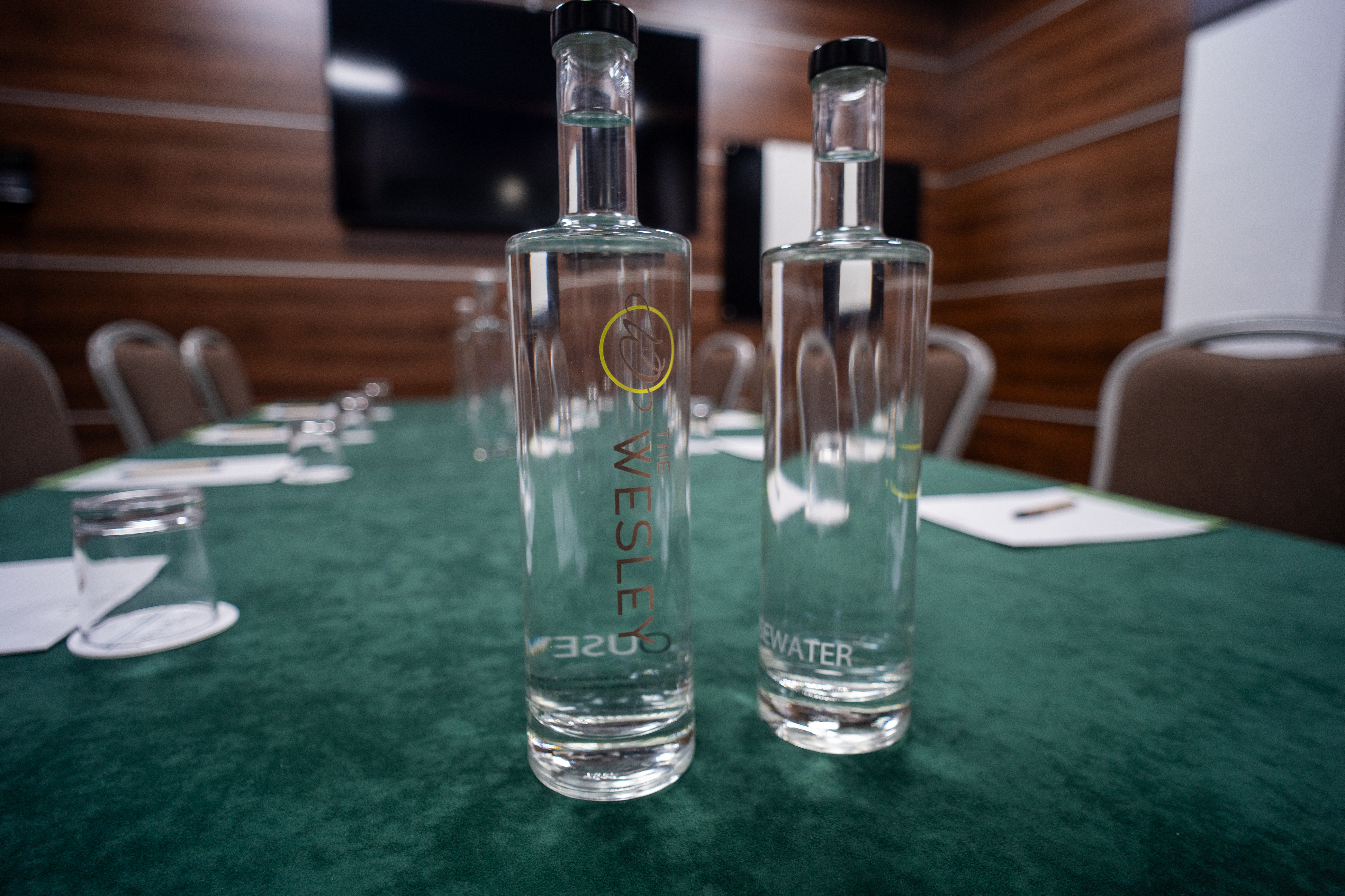 Glass bottles of water on a meeting room table at The Wesley