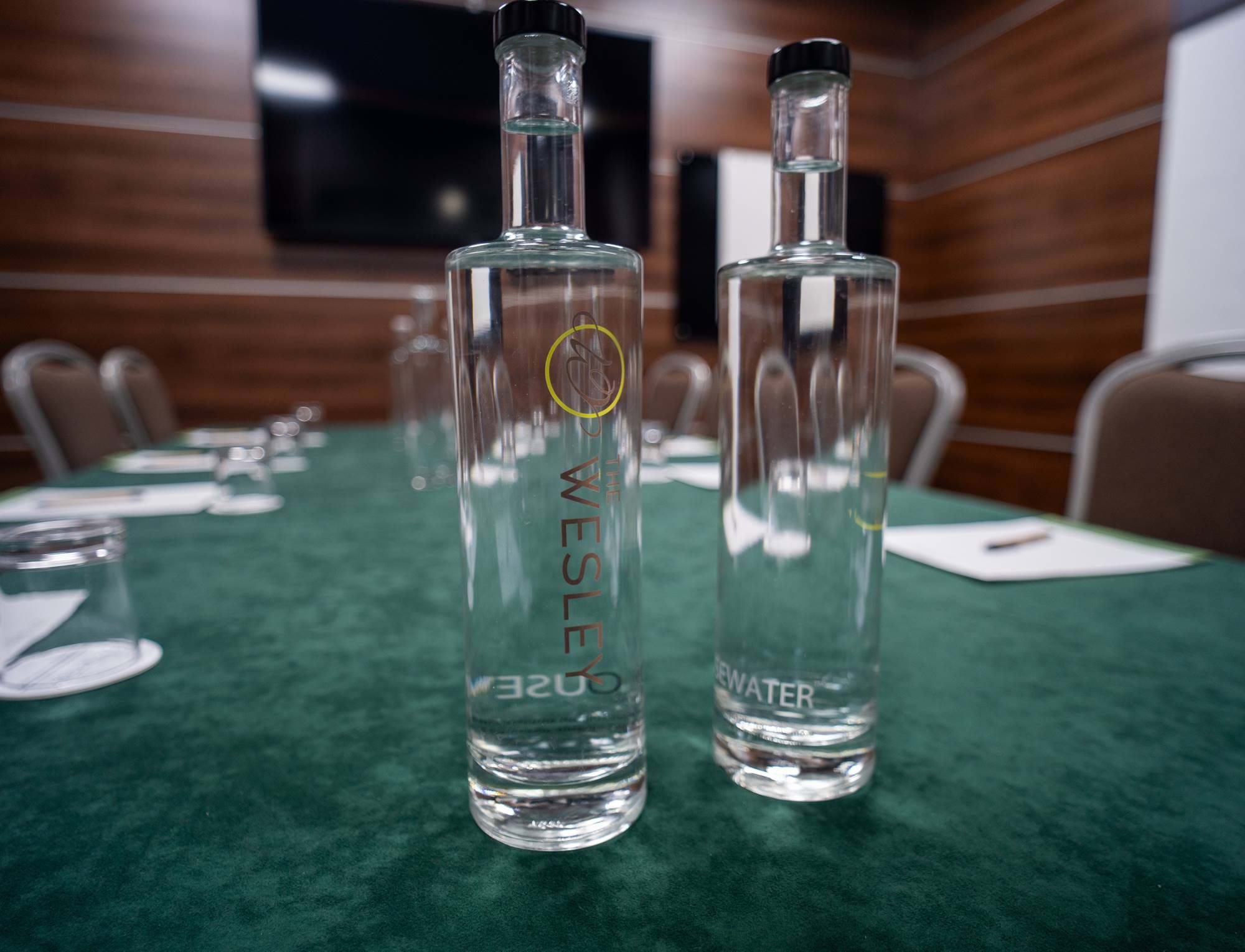 Glass bottles of water on a meeting room table at The Wesley