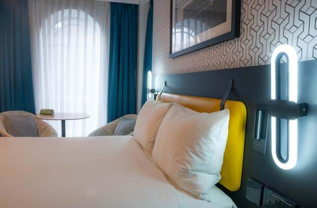 Bedroom with bed and pillows at The Wesley