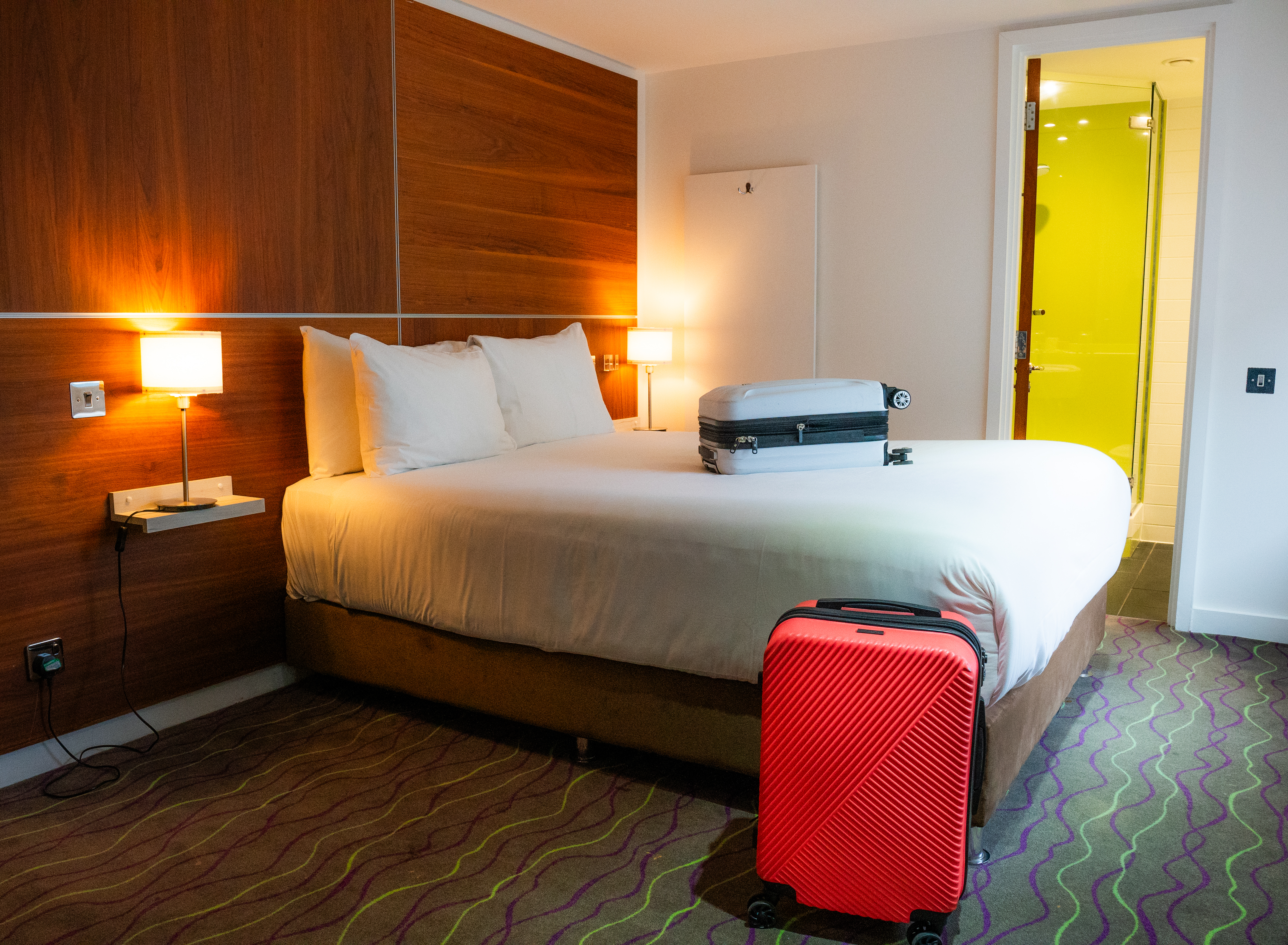 Suitcases on the bed at The Wesley